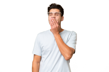 Young caucasian handsome man over isolated background yawning and covering wide open mouth with hand