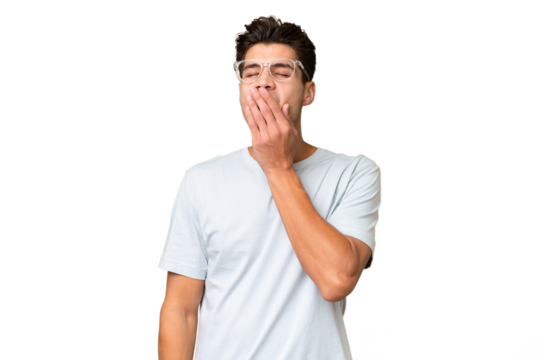 Young caucasian handsome man over isolated background yawning and covering wide open mouth with hand