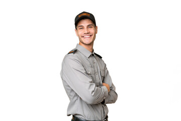 Young security man over isolated background with arms crossed and looking forward