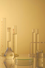Minimal concept with laboratory glassware - test tubes and beaker filled transparent liquid, petri...
