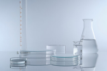 Minimal background with laboratory glassware containing colorless liquid decorated on white...