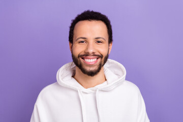 Photo of good mood cheerful positive man with curly hairstyle dressed white hoodie smiling dental ad isolated on purple color background