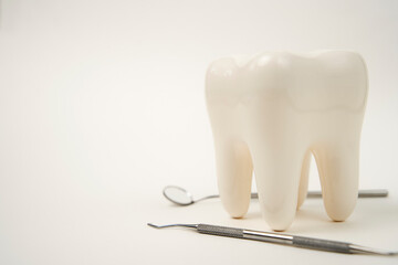 White healthy tooth, and dental tools for dentistry