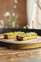Appetizing bruschetta with anchovy and cucumber