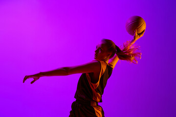 Throwing ball into basket. Female basketball player, young girl in motion, training, playing...
