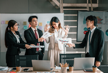 Businessperson is pressured by coworkers to do multitask in order to meet deadlines but feels overwhelmed and confused. Stress at work coupled with a lack of guidance and support from colleagues.
