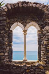 Naklejka premium Ancient old window with sea view. Porto Venere, Italy
