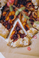 Top view of delicious homemade berry and fruit pastry on beige background in bakery