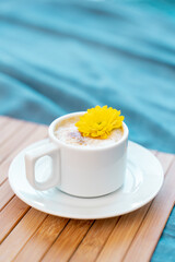 Cup of coffee with milk on a blue background with free space for text