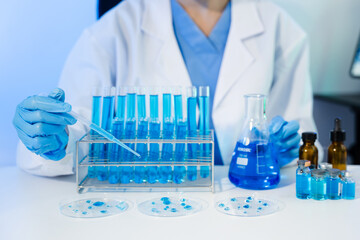 Female scientist researcher conducting an experiment working in the chemical laboratory.