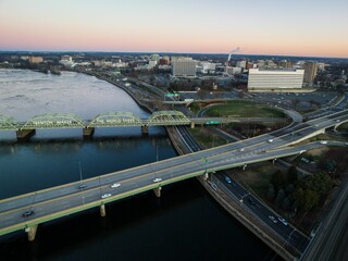 Aerial of the cityscape of Trenton, New Jersey, cars driving along the highways at sunrise