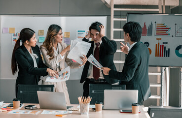 Businessperson is pressured by coworkers to do multitask in order to meet deadlines but feels overwhelmed and confused. Stress at work coupled with a lack of guidance and support from colleagues.