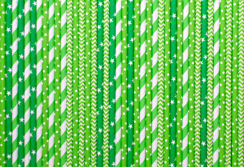 Paper straws. Green paper straws in close up. Green background