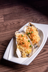 fresh western seafood steamed 2 big oyster shell with garlic ginger sauce in white plate on wood table luxury halal food fine dining restaurant menu