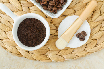 Ground coffee beans for preparing homemade exfoliating foot and body scrub. Natural beauty treatment and spa recipe. Top view.