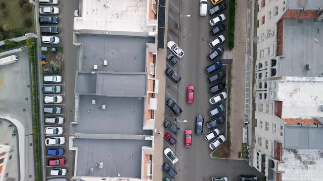 Top Down Shot of Two Red Cars Running on a Little Street