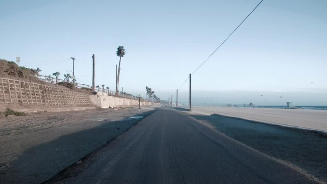 Landscape of an empty boardwalk on Huntington Beach under the sunlight in California
