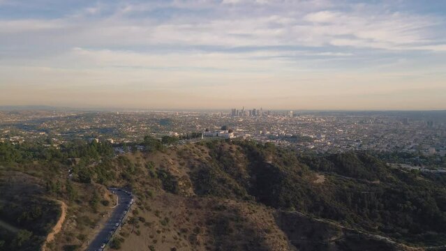 Drone view of the Griffith Observatory surrounded by greenery under the sunlight in California