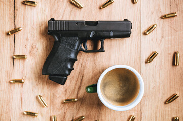 A small self-defense pistol and 9mm ammunition lie on the table with morning coffee.