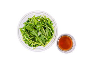 Fresh salad with arugula, mozzarella cheese, sun-dried tomato on a white background. Top view. Isolate