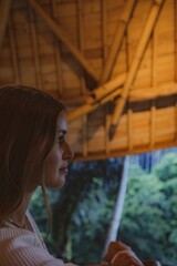 Vertical shot of a young girl in the home in Bali, Indonesia