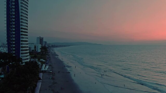 Aerial of Tonsupa beach and Grand Diamond Beach spa aparthotel at sunset in Ecuador.