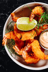fried big shrimps with seasonings in plate