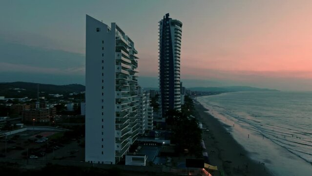 Aerial of Tonsupa beach and Grand Diamond Beach spa aparthotel at sunset in Ecuador.