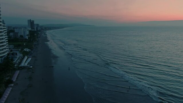 Aerial of Tonsupa beach and Grand Diamond Beach spa aparthotel at sunset in Ecuador.