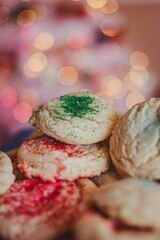 Plate with freshly baked Christmas cookies with sprinkles and bokeh lights in the background