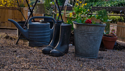 rain boots, bucket and watering can in the garden © A.R.