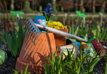 garden rake pots and flowers in the garden