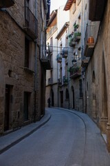 Fototapeta na wymiar Narrow street with traditional residential buildings in old town of Solsona in province of Barcelona