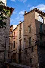 Narrow street with traditional residential buildings in old town of Solsona in province of Barcelona
