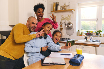 Daughter doing homework taking selfie on phone with family