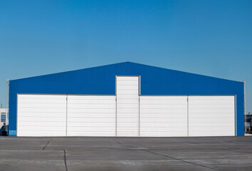 Fototapeta na wymiar Aviation hangar outside on a clear day