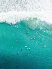View from above, stunning aerial view of a person surfing on a turquoise ocean. Fuerteventura, Canary Islands, Spain. © Travel Wild