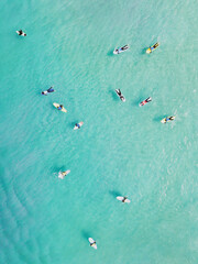 View from above, stunning aerial view of a person surfing on a turquoise ocean. Fuerteventura, Canary Islands, Spain.