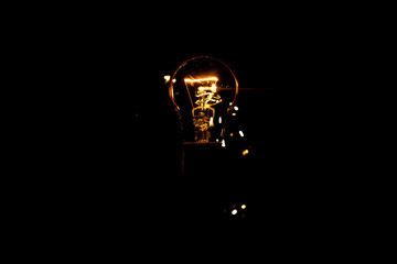 Light and sparks from a burning incandescent lamp. Short circuit.