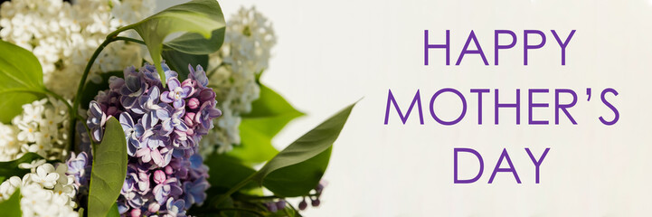 happy mother's day text sign. greeting card. spring flat lay. purple lilac flowers on white...