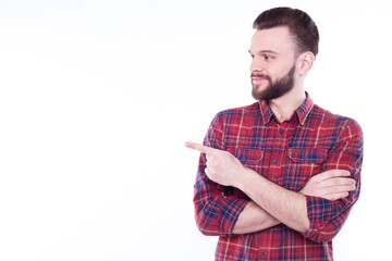 Strong, confident, handsome and bearded man in casual checkered shirt is posing isolated on white background with copy space for text and advertising