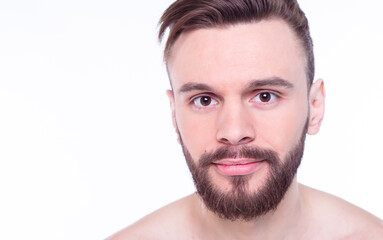 Fototapeta premium Handsome, attractive, brutal, modern, manly, confident, naked man touching his perfect, ideal face skin, looking at camera and posing isolated on white background after bath
