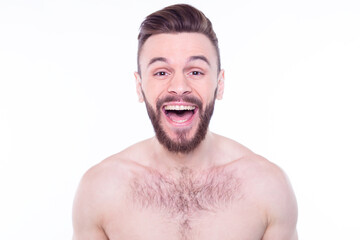 Handsome, attractive, brutal, modern, manly, confident, naked man touching his perfect, ideal face skin, looking at camera and posing isolated on white background after bath