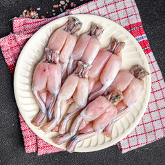frog legs raw meat fresh meal food snack on the table copy space food background rustic top view