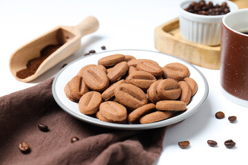 Concept of tasty snack for hot drink - cookies in the shape of coffee seeds