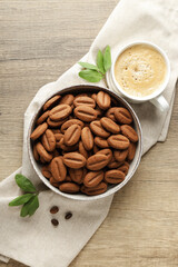 Concept of tasty snack for hot drink - cookies in the shape of coffee seeds