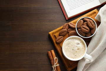 Concept of tasty snack for hot drink - cookies in the shape of coffee seeds
