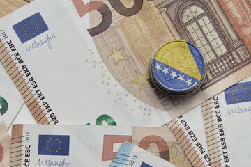 euro coin with national colorful flag of bosnia and herzegovina on the euro money banknotes...