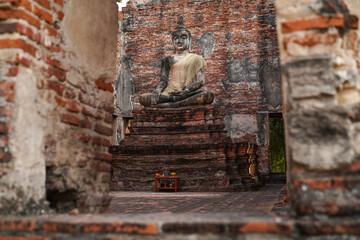 ruins and monks in church in Wat Borom Phuttharam Ayutthaya, Thailand