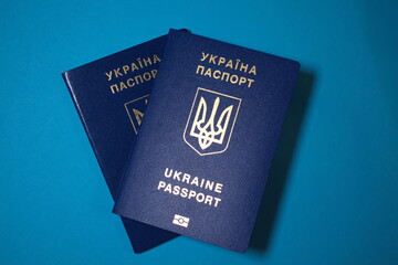 Ukrainian passports isolated on a blue background. Travel concept. immigration issues. Free space for your text. Freedom, independence country. Identity card in Ukraine